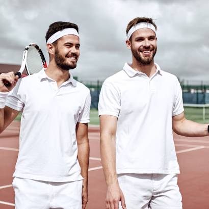Business, partnership and sport. Business partners practicing sport together. Young men walking and looking to tennis court before a tennis set